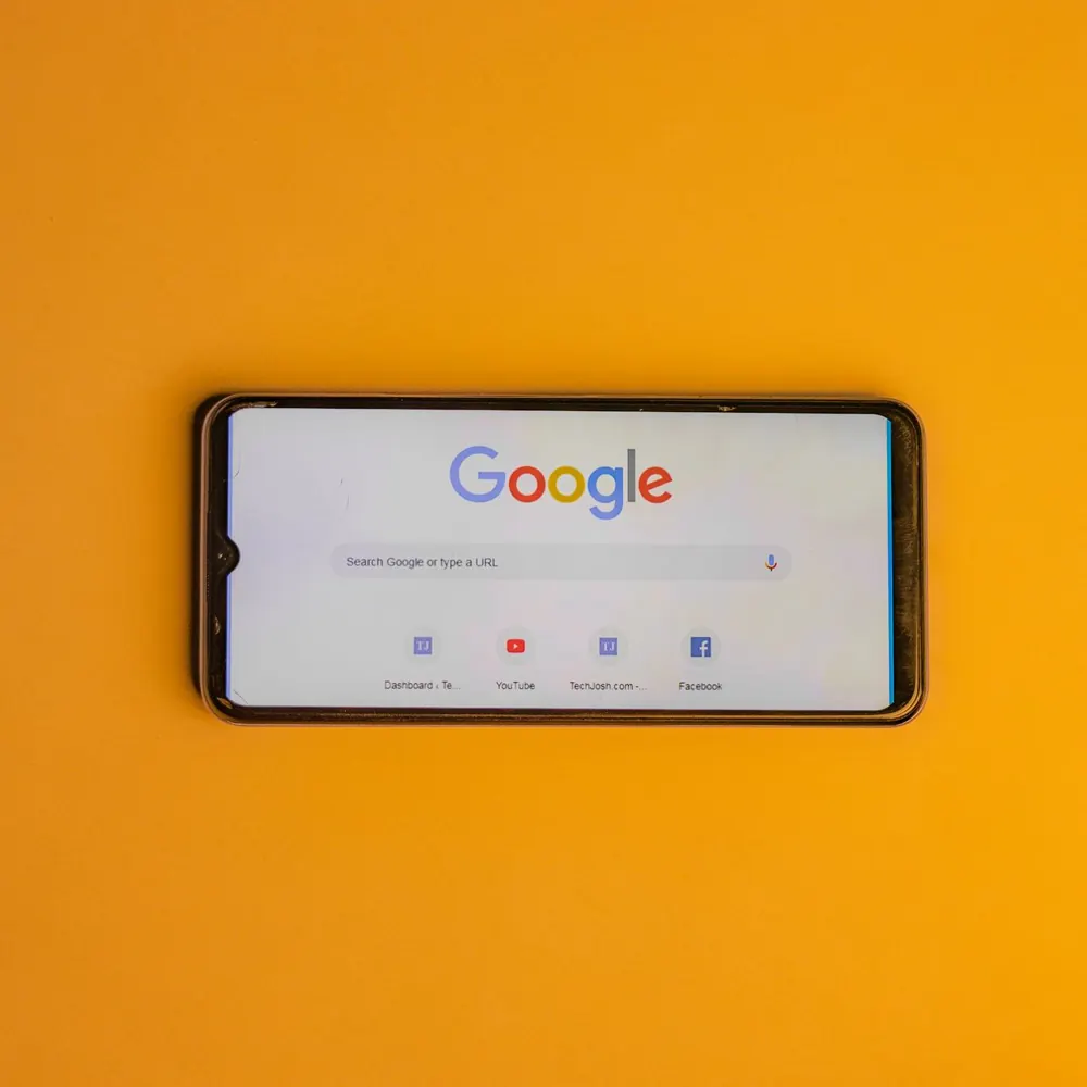 Google search open on a phone against a yellow background
