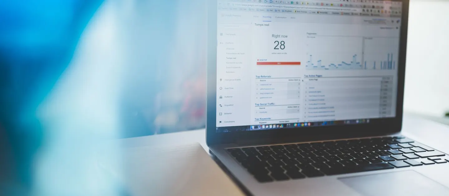 A laptop showing Google Analytics in a workspace